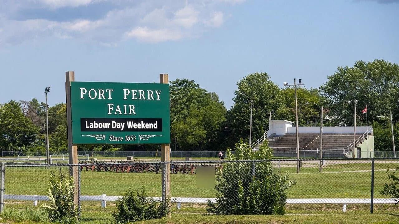 Port Perry Fair grounds entrance sign and grandstand with no identifiable people.
